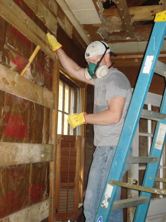 Removing ceiling tiles and  faux wood paneling in the family room. 