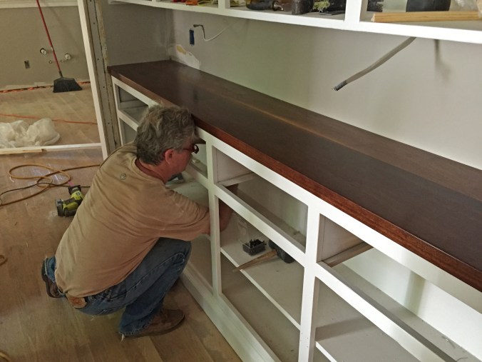 Fastening it from underneath, so we don't mar the wood. 